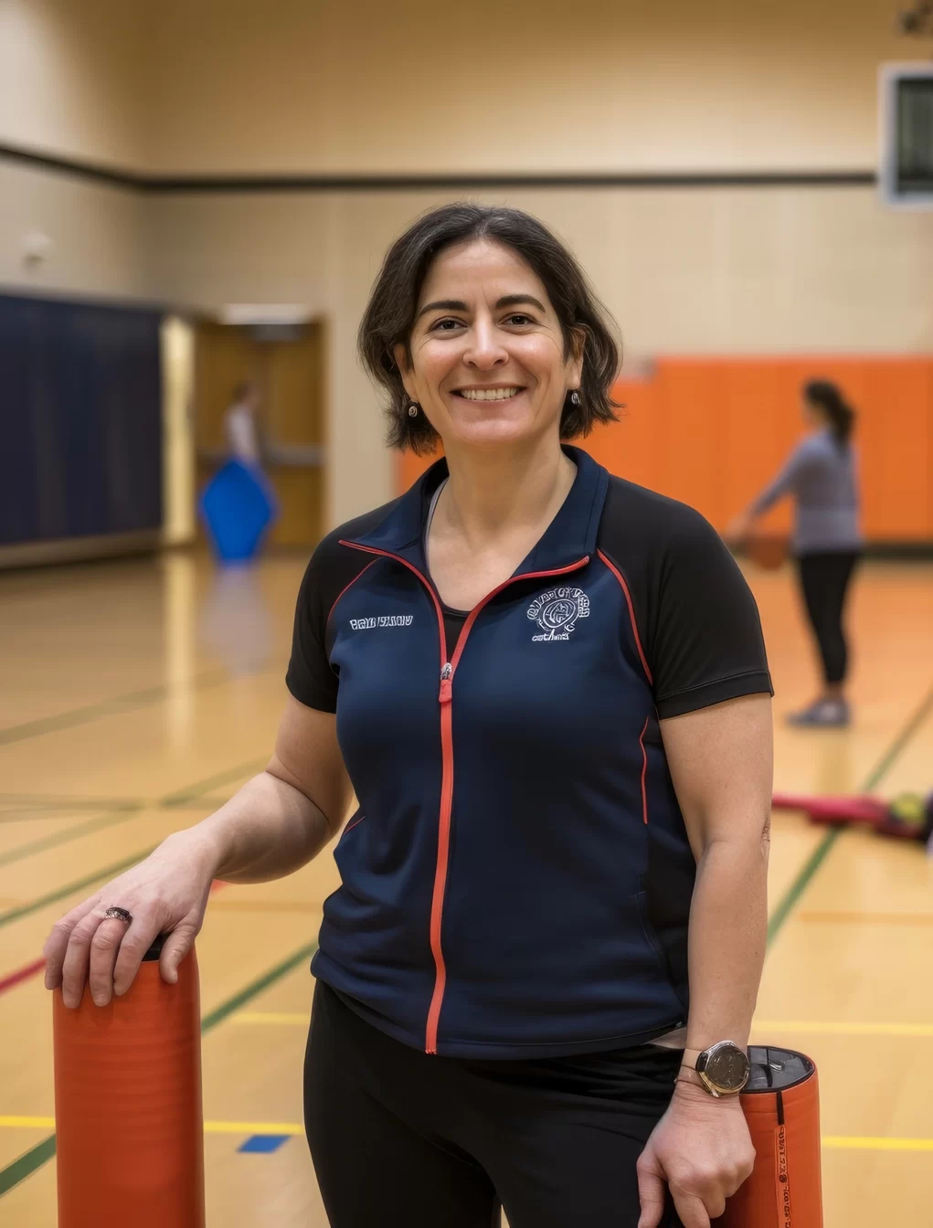 portrait-enthusiastic-energetic-female-teacher-gymnasium-wearing-workout-clothes